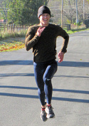 Men's course record holder Seumas O'Reilly finishing the 2013 Greasy-Gooney 10K