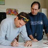 Terry Leckie and Patrick Farris working on the results of the 2003 Greasy-Gooney 10K